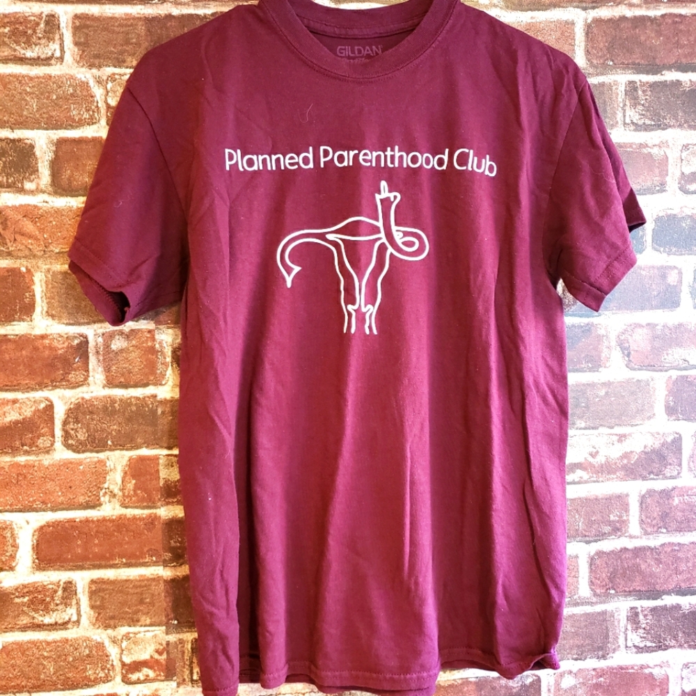 PLANNED PARENTHOOD SHIRT. Uterus gives the finger. Maroon shirt